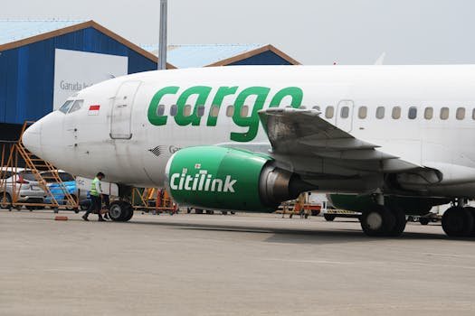 A Citilink cargo plane being prepared for logistics at an airport terminal.
