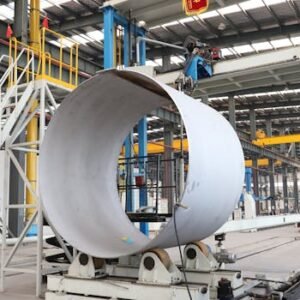 A spacious industrial factory scene showcasing steel pipe production with modern machinery.